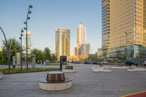 a park with benches and buildings in a city at BOULEVARD NEST RESlDENCE in Tashkent +32 photos