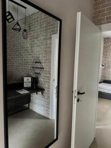 a mirror in a room with a brick wall at Typic loft Alghero in Alghero +23 photos