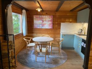 a kitchen with a table and chairs in a room at Ruhige Hütte mit toller Aussicht in Dammbach