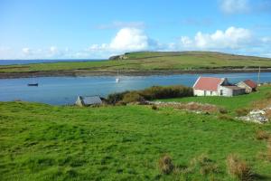 a group of houses on a hill next to a body of water at Rockmount House B&B in Clifden +19 photos