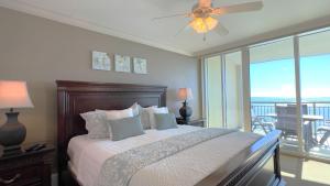 a bedroom with a bed with a view of the ocean at Mar Vista Grande - 806 in Myrtle Beach
