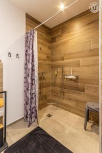 a bathroom with a shower with wooden walls at Coeur de fournache in Saint-Jean-de-Maurienne +45 photos