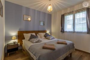 a bedroom with a large bed with two pillows on it at Coeur de fournache in Saint-Jean-de-Maurienne
