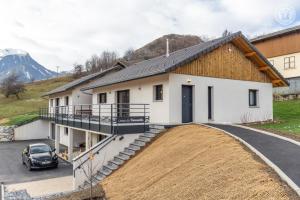a house with a driveway and a car parked in front at Coeur de fournache in Saint-Jean-de-Maurienne