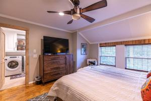 a bedroom with a bed and a flat screen tv at Four Bear Falls in Banner Elk