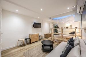 un salon avec un canapé et une table dans l'établissement ARCO Gran Via Boutique Apartments, à Madrid