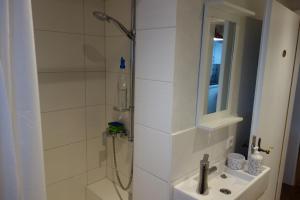 a white bathroom with a shower and a sink at Lilo Luisa in Weinheim +20 photos