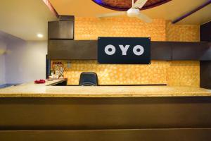 a qo sign on the wall of a restaurant at Hotel O Crystal in Ahmedabad