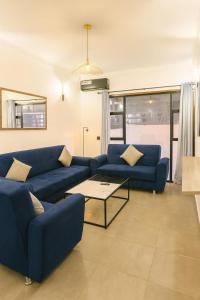 a living room with blue couches and a table at Sublime Appartement Marrakech in Marrakech