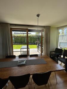 a dining room with a wooden table and chairs at Stephens Bay Delight Kaiteriteri in Kaiteriteri