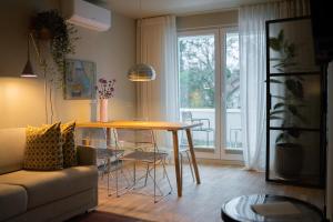 a living room with a table and a couch at Pievos in Birštonas