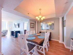 a dining room and kitchen with a table and chairs at Barefoot North Tower - 1203 in Myrtle Beach