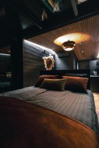 a bedroom with a bed with a dog on the wall at Arctic Lumo Resort in Kuusamo