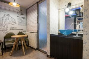 a bathroom with a sink and a table at v motel in Busan +61 photos