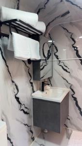 a bathroom with a sink and a mirror at The Out Resort in Sinādil