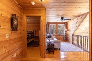 a log cabin hallway with a bedroom and a bed at Whiskey Bear Escape in Fleetwood