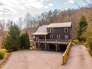 a large house with a porch and a driveway at Whiskey Bear Escape in Fleetwood