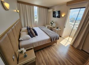 Ένα ή περισσότερα κρεβάτια σε δωμάτιο στο Hotel Santoni