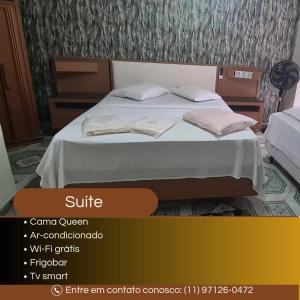 a bed with two pillows on it in a room at Hospedaria Monumento in Sao Paulo