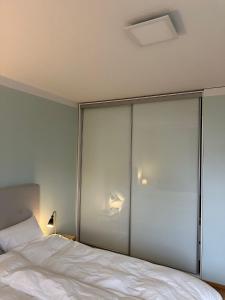 a bedroom with a bed with sliding glass doors at 2 room apartment in Pasila in Helsinki