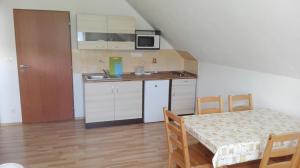a small kitchen with a table and a dining room at Penzion Kabourek in Vítkovice