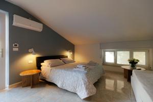 um quarto com uma cama grande e uma janela em Bed & Breakfast L'Albero Maestro em Borgofranco dʼIvrea