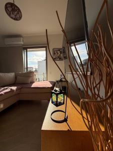 a living room with a couch and a table at Central Nicosia Haven in Nicosia