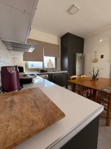 a kitchen with a white counter top and a table at Central Nicosia Haven in Nicosia +23 photos