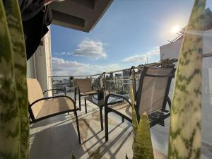 a balcony with chairs on top of a building at Central Nicosia Haven in Nicosia