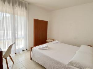 Postel nebo postele na pokoji v ubytování Hotel Rosa Dei Venti + 28 fotografií