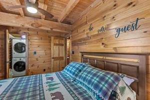a bedroom with a bed in a log cabin at The Great Bear Lodge in Vilas +42 photos