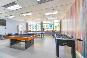a room with two billiard tables and a colorful wall at Bright & Modern Condo in Brickell w Pool Access in Miami