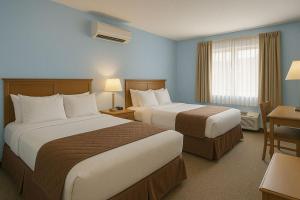 Ένα ή περισσότερα κρεβάτια σε δωμάτιο στο Sunset Grove Hotel