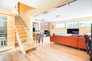 a living room with a staircase and a couch at Fresh Space Quiet Air Studio in Mercer Island