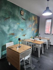 a dining room with tables and a wall with fishes at Affittacamere Casa Marconi in Comacchio
