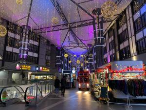 a shopping mall with christmas lights and people walking through it at Jo’s Place Cameron Highlands EA922 in Brinchang