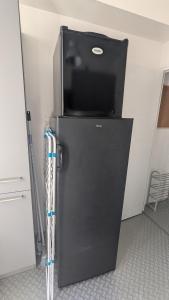 a black refrigerator in a room with at Appartement Hyper Centre, 2ème étage in Fougères +24 photos