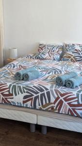 a bed with blankets and pillows on it at Appartement Hyper Centre, 2ème étage in Fougères