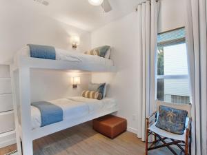two bunk beds in a room with a window at Lime Time in Tybee Island +33 photos