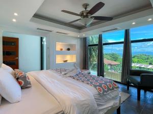 a bedroom with a bed and a ceiling fan at Casa Cielo Luxury Jungle Retreat, Manuel Antonio in Quepos +38 photos
