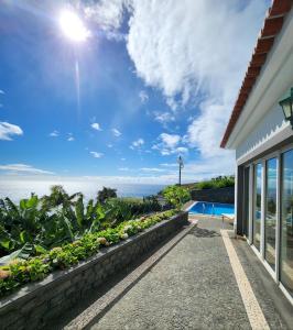 a view of the ocean from a house at Villa Ocean Wave Calheta - Heated Pool & Stunning Ocean View in Calheta