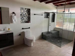 a bathroom with a shower and a toilet and a sink at Colombia Escape - Cafe Acapulco Extasis in Viterbo