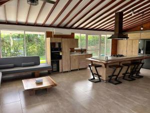 a kitchen with a couch and a table in a room at Colombia Escape - Cafe Acapulco Extasis in Viterbo