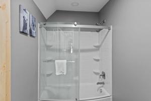 a shower with a glass door in a bathroom at Bear Necessities in Beech Mountain +38 photos