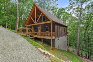 a large wooden cabin in the middle of the woods at Bear Necessities in Beech Mountain