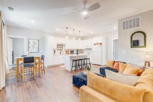 a living room and kitchen with a couch and a table at The Pearl Hotel in Manteo