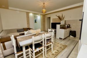 een eetkamer en woonkamer met een tafel en stoelen bij LuxuryHomeUlcinj2 in Ulcinj