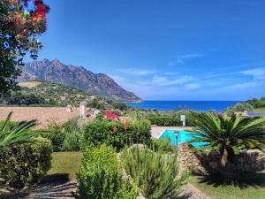 a resort with a swimming pool and the ocean at Villa Sa Perla - Pool, Panoramic View, 250m to Seafront, 650m to Beach in Marina di Gairo