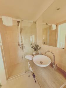 a bathroom with a sink and a shower at Trio Apartments in Ostrava +15 photos