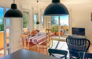 a kitchen and dining room with a table and chairs at Lovely Home In Almuñecar With Ethernet Internet in Almuñécar